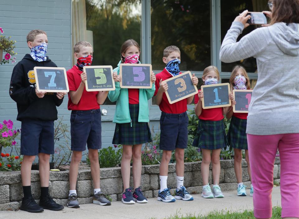 No one expected the first day of school to look like this: Lacey Tomczuk captures what has always been a precious moment for parents before her children board the bus Aug. 31 in Bayside, Wis.