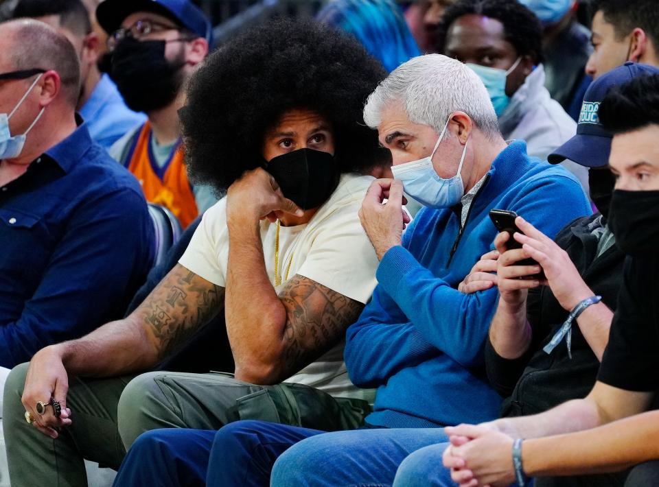 November 6, 2021; Phoenix, USA; Colin Kaepernick and Suns Vice Chairman Jahm Najafi talk on the front row seats of the Suns vs. Hawks game during the second half at the Footprint Center.