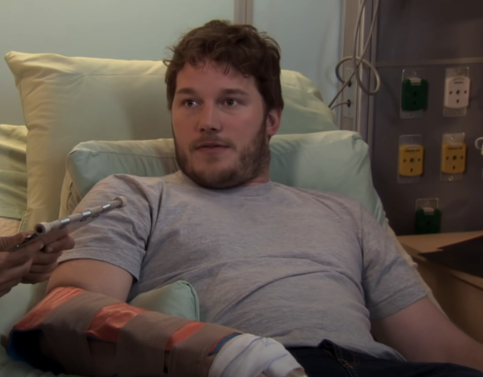 chris in a hospital bed as andy dwyer