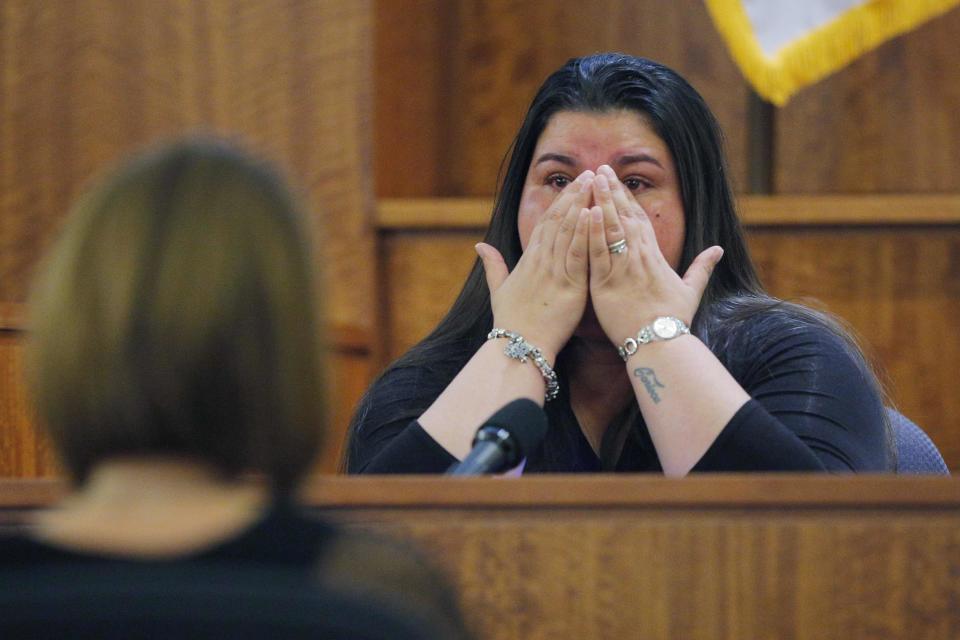 House cleaner Carla Barbosa wipes her face, while testifying in the murder trial of former New England Patriots player Aaron Hernandez, at Bristol County Superior Court in Fall River, Massachusetts, February 24, 2015. Hernandez is accused of the murder of Odin Lloyd in June 2013. REUTERS/Brian Snyder (UNITED STATES - Tags: CRIME LAW SPORT FOOTBALL)