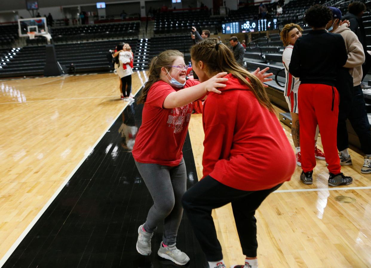 Emmy Sheldon hugs her sister Jacy Sheldon after a game in 2021.