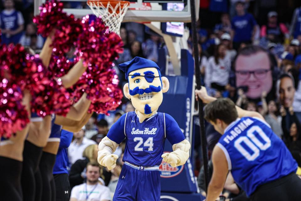 Feb 24, 2024; Newark, New Jersey, USA; The Seton Hall Pirates mascot performs in front of flagman and the dance team during the second half of the game between the Pirates and the Butler Bulldogs at Prudential Center. Mandatory Credit: Vincent Carchietta-USA TODAY Sports