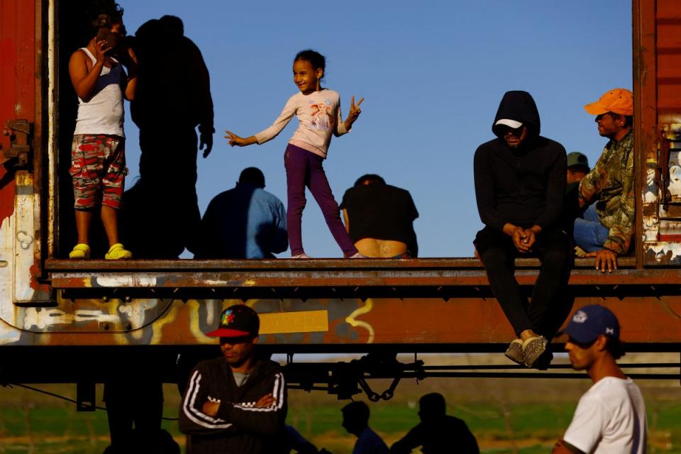 Victoria, a seven-year-old migrant girl, plays inside a carriage as she travels with her family (Reuters)