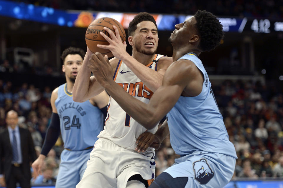 Phoenix Suns guard Devin Booker (1) drives against Memphis Grizzlies forward Jaren Jackson Jr., right, in the second half of an NBA basketball game Sunday, Jan. 26, 2020, in Memphis, Tenn. (AP Photo/Brandon Dill)