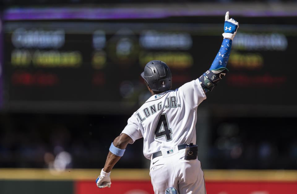 Seattle Mariners' Shed Long Jr. celebrates as he rounds the bases after hitting a grand slam off Tampa Bay Rays relief pitcher Diego Castillo that also scored Luis Torrens, Dylan Moore and Jake Bauers during the 10th inning of a baseball game, Sunday, June 20, 2021, in Seattle. (AP Photo/Stephen Brashear)