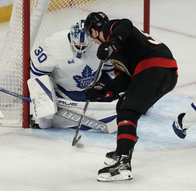 Ottawa Senators center Shane Pinto tries to move the puck past Toronto Maple Leafs goaltender Matt Murray during the first period of an NHL hockey game, Saturday, March 18, 2023 in Ottawa, Ontario. (Adrian Wyld/The Canadian Press via AP)