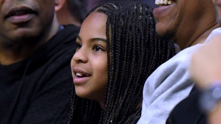 Out with her famous father, Blue Ivy Carter smiles during a game last year between the Los Angeles Lakers and the L.A. Clippers at Staples Center. (Photo: Harry How/Getty Images)