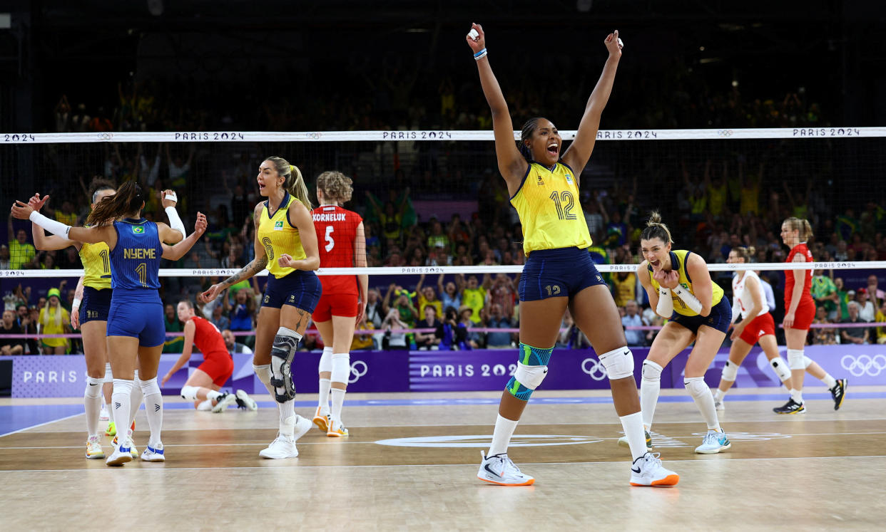 Ana Cristina Menezes Oliveira de Souza of Brazil celebrates after the women's Brazil vs. Poland volleyball match on Sunday. 