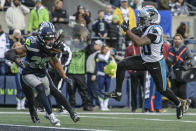 Carolina Panthers running back Raheem Blackshear (20) leaps into the end zone for a touchdown against Seattle Seahawks safety Ryan Neal (26) during the second half of an NFL football game, Sunday, Dec. 11, 2022, in Seattle. (AP Photo/Caean Couto)
