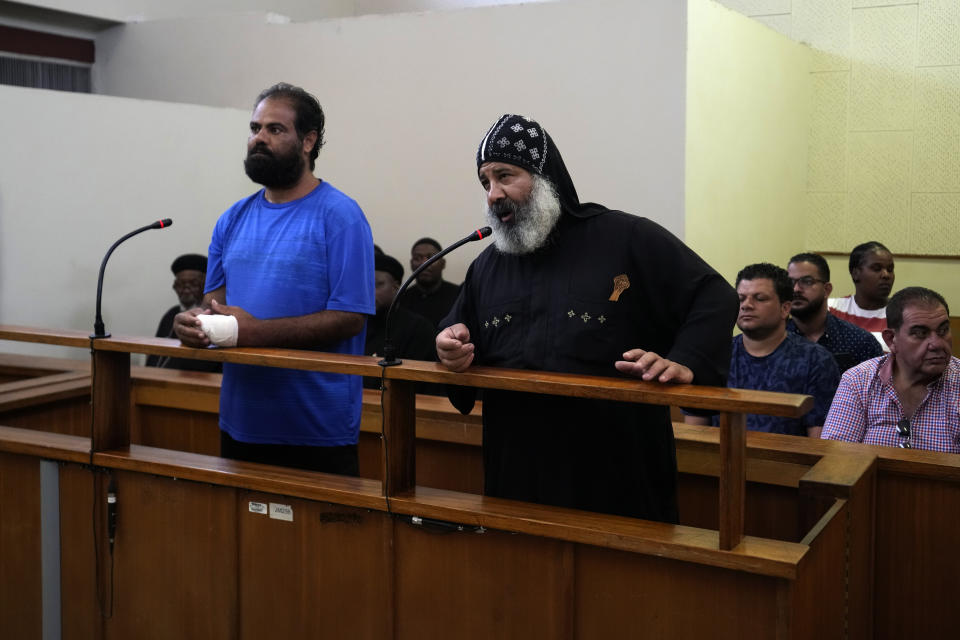 Two suspects appear at the magistrate court in Cullinan, a town east of Pretoria, South Africa, Thursday, March 14, 2024. The two suspects appeared at the court for the murder of three Egyptian monks belonging to the Coptic Orthodox Church at a monastery in South Africa. (AP Photo/Themba Hadebe)