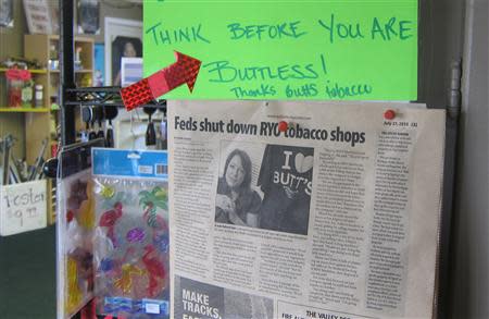 A sign in the Butt's Tobacco store near Seattle informs customers of a federal raid that shut down the store's cigarette rolling business in a strip mall south of Seattle, in this photo taken July 24, 2013. REUTERS/Andy Sullivan