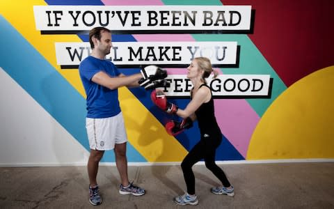 Henrietta and Barnaby Rodgers taking part in a punch and pad class - Credit: Rii Schroer