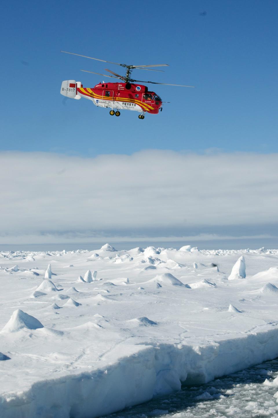A helicopter from the Xue Long Chinese icebreaker prepares to unload rescued passengers from the ice-bound Russian ship, Akademik Shokalskiy, in East Antarctica, in this handout courtesy of Fairfax's Australian Antarctic Division