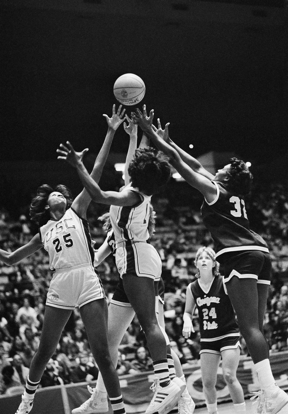 FILE -The ball bounces away from Southern Californias JaMaiia Bond (25), and Juliette Robinson, center, and Kym Hampton, right, and Jessica Wiley (24) of Arizona State during their NCAA West Region Womens Basketball Championship game, Thursday, March 25, 1983, Los Angeles. How well do you think you know the women’s NCAA Tournament? Try your luck at this AP trivia quiz about the history of March Madness. Don’t cheat! (AP Photo/Nick Ut, File)