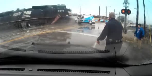 Man jumps from van seconds before train hits (video)