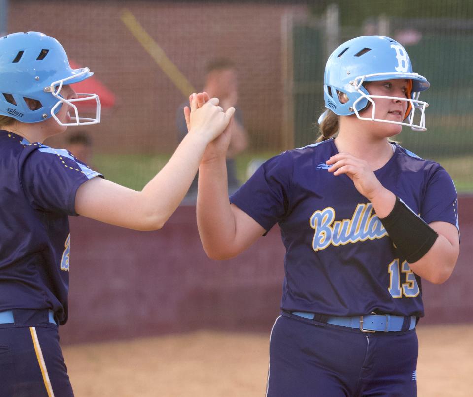 Burns' Sayge Strange high-fives a teammate after coming in to score during their April 12, 2022 matchup against East Gaston.