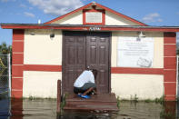 Pastor Louicesse Dorsaint opens the door to his church Haitian United Evangelical Mission which was damaged by flooding from Hurricane Irma in Immokalee, Florida, U.S. September 12, 2017. REUTERS/Stephen Yang