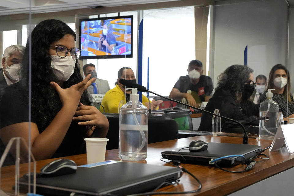 Giovanna Gomes Mendes testifies before a Senate committee investigating the handling of the COVID-19 pandemic by the administration of President Jair Bolsonaro in Brasilia, Brazil, Monday, Oct. 18, 2021. Giovanna said she lost both her parents to the new coronavirus over a two week period. (AP Photo/Eraldo Peres)