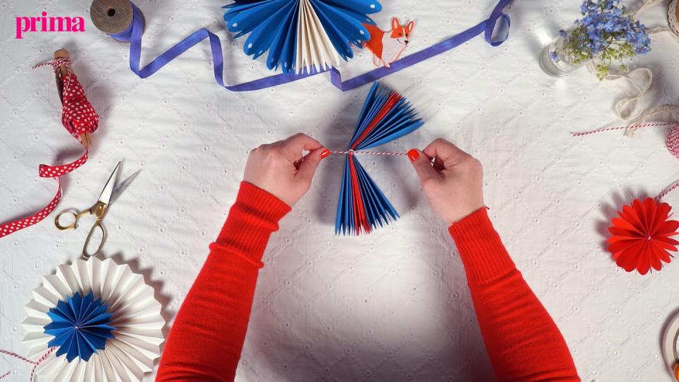 secure paper fan decoration with twine