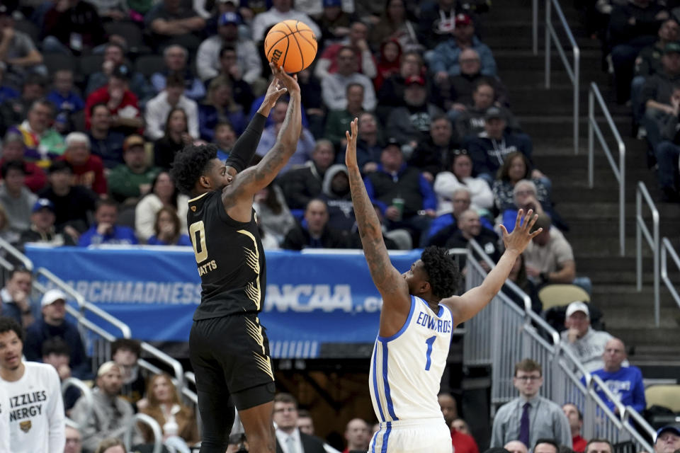 Oakland's Rocket Watts (0) shoots over Justin Edwards (1) during the second half of a college basketball game in the first round of the men's NCAA tournament Thursday, March 21, 2024, in Pittsburgh. (AP Photo/Matt Freed)