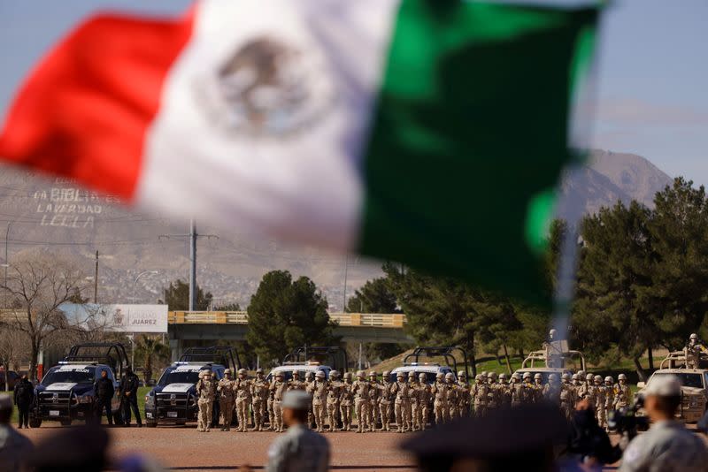 FILE PHOTO: Members of the Mexican army and police officers participate in the commemoration of Flag Day in Ciudad Juarez