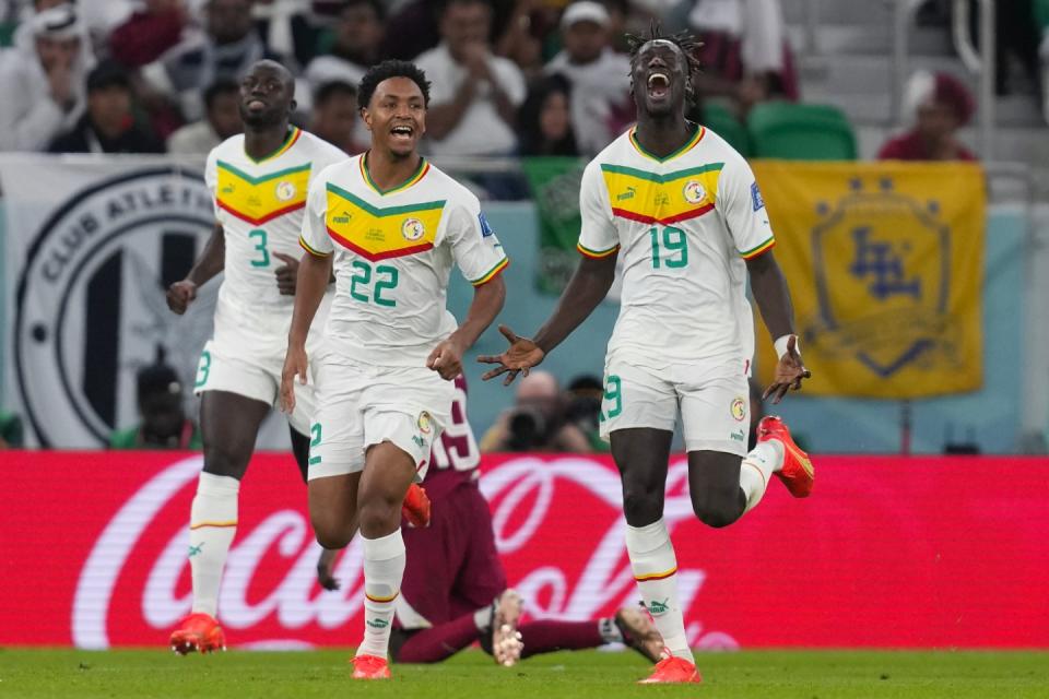 Senegal's Famara Diedhiou celebrates after scoring his side's second goal during the World Cup group A football match between Qatar and Senegal, at the Al Thumama Stadium in Doha, Qatar, Friday, Nov. 25, 2022. (AP Photo/Thanassis Stavrakis)