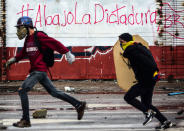 <p>Anti-government activists clash with riot police during a protest in Caracas on July 28, 2017. (Photo: Ronaldo Schemidt/AFP/Getty Images) </p>