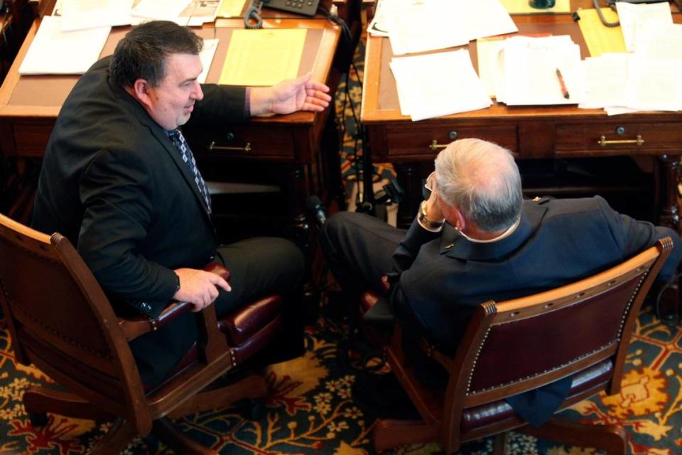 Kansas state Sen. Rob Olson, R-Olathe, left, converses with Sen. Ron Ryckman Sr., R-Meade, during a debate at the Statehouse in Topeka last month. Olson is a key player in the drafting of the final version of a bill aimed at modernizing the state’s unemployment system and giving legislators more oversight of technology upgrades at the Kansas Department of Labor.