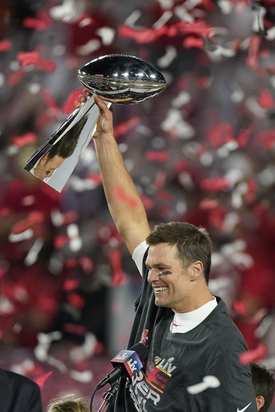 FILE - Tampa Bay Buccaneers quarterback Tom Brady celebrates with the Vince Lombardi Trophy after the NFL Super Bowl 55 football game against the Kansas City Chiefs on Feb. 7, 2021, in Tampa, Fla. The Buccaneers defeated the Chiefs 31-9 to win the Super Bowl. (AP Photo/Gregory Bull, File)