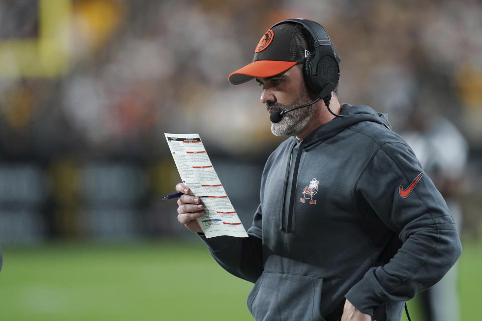 Cleveland Browns head coach Kevin Stefanski looks at his playbook on the sideline during the first half of an NFL football game against the Pittsburgh Steelers Monday, Sept. 18, 2023, in Pittsburgh. (AP Photo/Matt Freed)