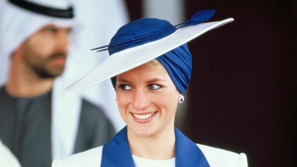 Diana, Princess of Wales, wears a Catherine Walker suit and a Philip Somerville turban hat during her official tour of the Gulf States on March 17, 1989 in Dubai, United Arab Emirates