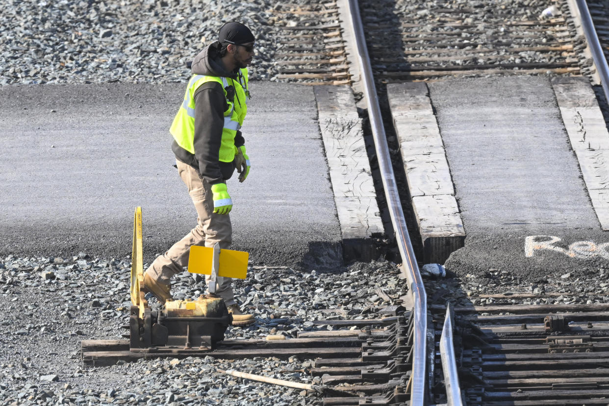 FILE - A rail worker switches a track for a Locomotive in the Selkirk rail yard, Wednesday, Sept. 14, 2022, in Selkirk, N.Y.Most railroad workers weren't surprised that Congress intervened this week to block a railroad strike, but they were disappointed because they say the deals lawmakers imposed didn't do enough to address their quality of life concerns about demanding schedules and the lack of paid sick time. (AP Photo/Hans Pennink, File)