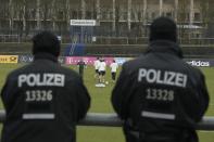 Police follow a training session of the German national team in Berlin on March 22, 2016