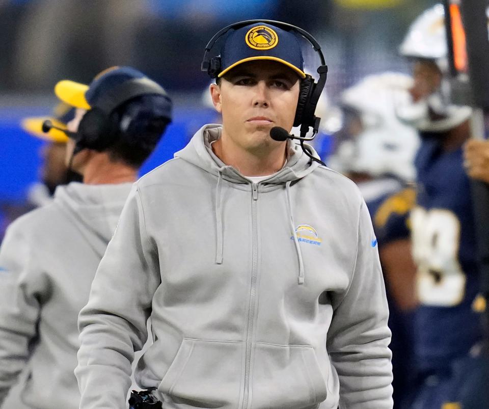 FILE - Los Angeles Chargers offensive coordinator Kellen Moore stands on the sideline during an NFL football game against the Baltimore Ravens, Nov. 27, 2023, in Inglewood, Calif.