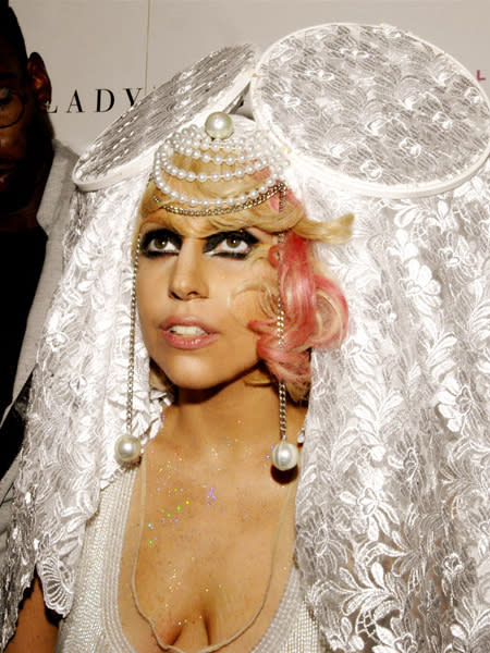 <p>Gaga's final look of the night? A white sequined mini dress with white mesh overlay, topped with a Victorian-esque head piece replete with pearls, beading and lace-covered circles the size of dinner plates. All we can say is, Gaga knows how to take a fashion risk.</p>