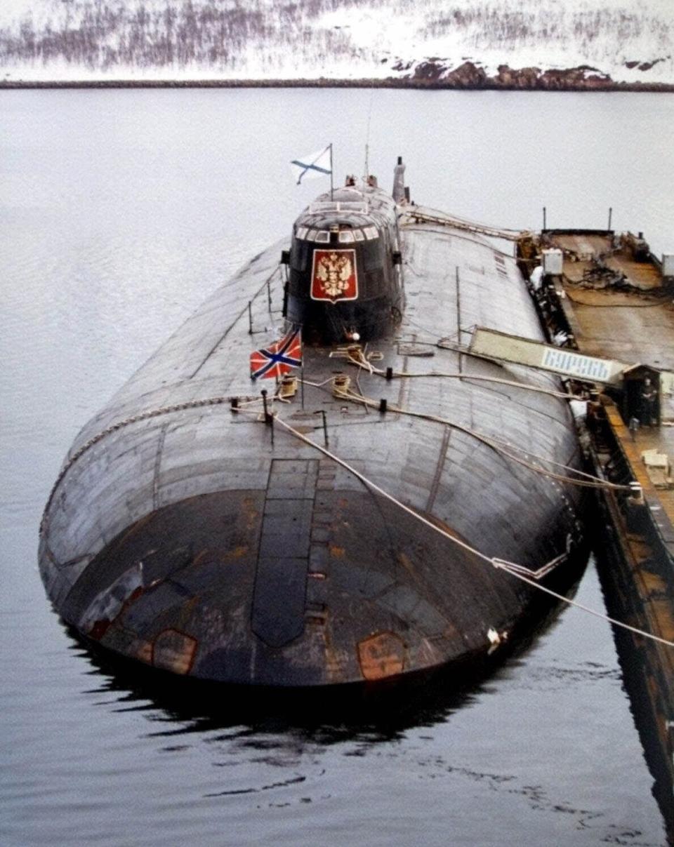 FILE - The Russian nuclear submarine Kursk, is shown at a Navy base in Vidyayevo, Russia, May 2000. Retired Vyacheslav Popov has alleged in an interview released Monday Nov. 22, 2021, that the 2000 Kursk submarine disaster was caused by a collision with a NATO sub, an unproven claim that defies the official conclusion that the country's worst post-Soviet naval catastrophe was triggered by a faulty torpedo. (AP Photo/File)