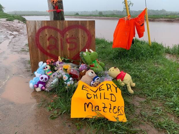 A memorial beside the Shubenacadie River was set up in May to remember the 215 children whose remains were discovered buried at the site of the former Kamloops Indian Residential School. (Shaina Luck/CBC - image credit)