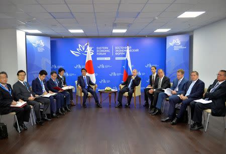 Members of the Russian delegation, led by President Vladimir Putin, meet with members of the Japanese delegation, led by Prime Minister Shinzo Abe, on the sidelines of Eastern Economic Forum in Vladivostok, Russia, September 2, 2016. Sputnik/Kremlin/Alexei Druzhinin/via REUTERS