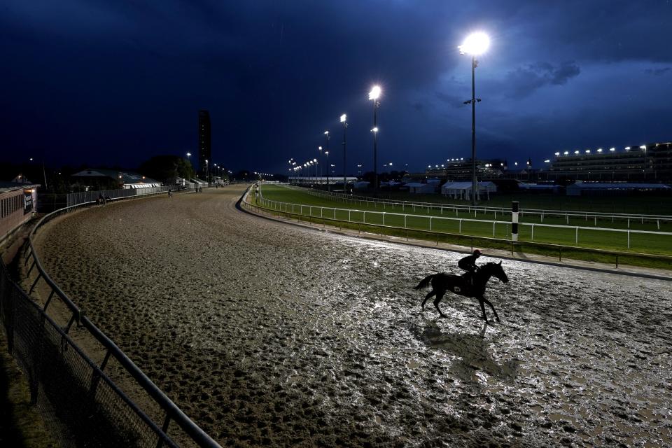 Horses work out in the rain at Churchill Downs Tuesday, May 3, 2022, in Louisville, Ky. The 148th running of the Kentucky Derby is scheduled for Saturday, May 7. (AP Photo/Charlie Riedel)