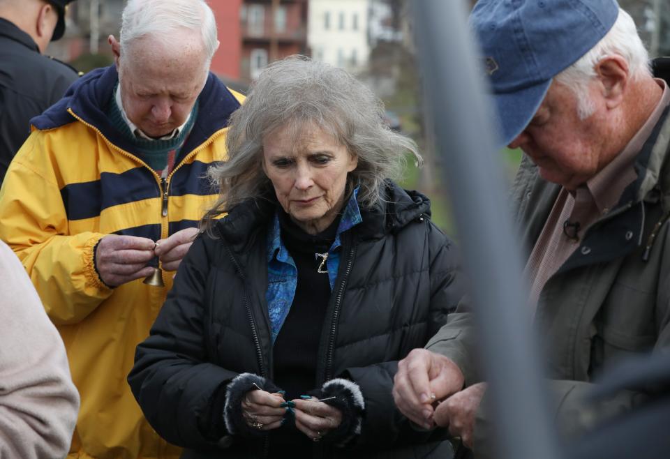 Bailey Kids actors Ron Collins, left, his twin Don Collins, and Karolyn Grimes prepare bells to hang on the Bridge Street Bridge, which inspired director Frank Capra's bridge scene in the Christmas classic movie It's a Wonderful Life, during a special "Every Time a Bell Rings ... In Memory of Menzo Case" event at the It's A Wonderful Life Festival in Seneca Falls, NY Friday, Dec. 8, 2023.