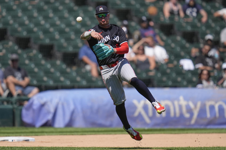 Minnesota Twins third baseman Jose Miranda throws to first baseman Carlos Santana to force out Chicago White Sox's Korey Lee during the eighth inning in the first baseball game of a doubleheader, Wednesday, July 10, 2024, in Chicago. (AP Photo/Erin Hooley)