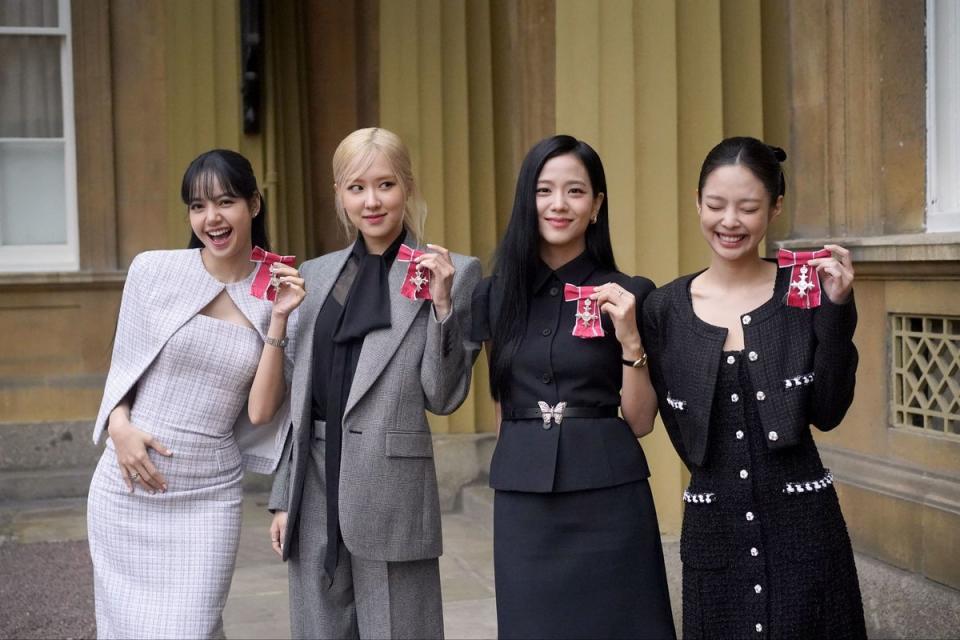 Jennie, far right, joins her bandmates in receiving Honorary MBEs (PA)