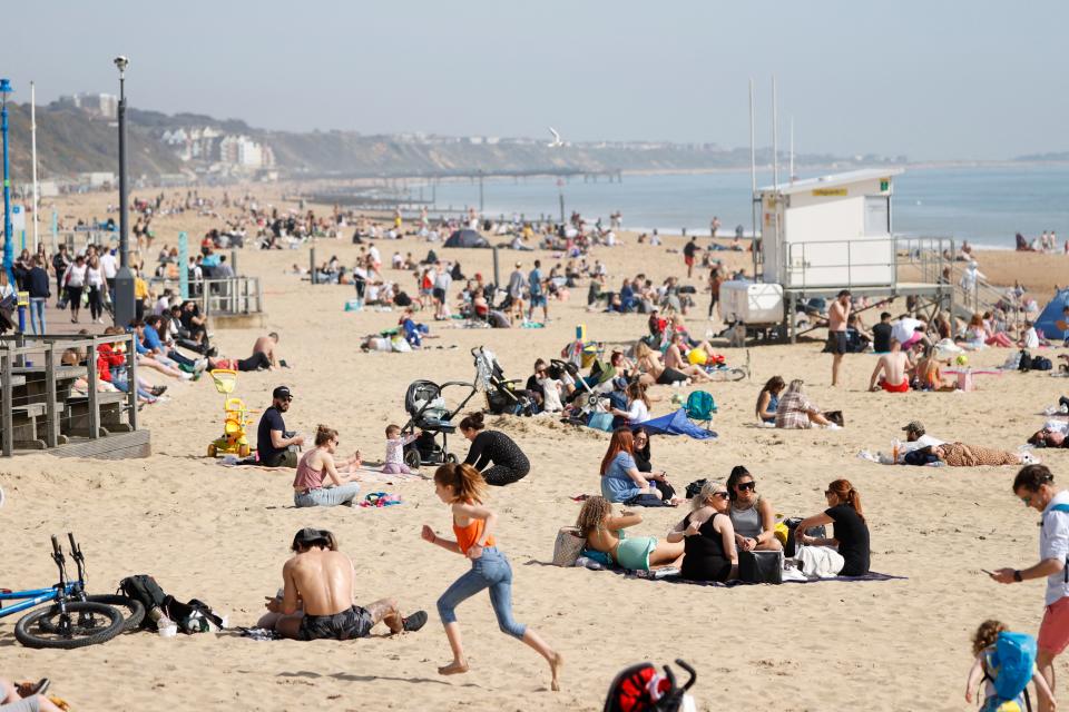 Members of the public enjoy the beach in Bournemouth, southwest England as a spell of warm weather covers the country on March 30, 2021. (Photo by Adrian DENNIS / AFP) (Photo by ADRIAN DENNIS/AFP via Getty Images)