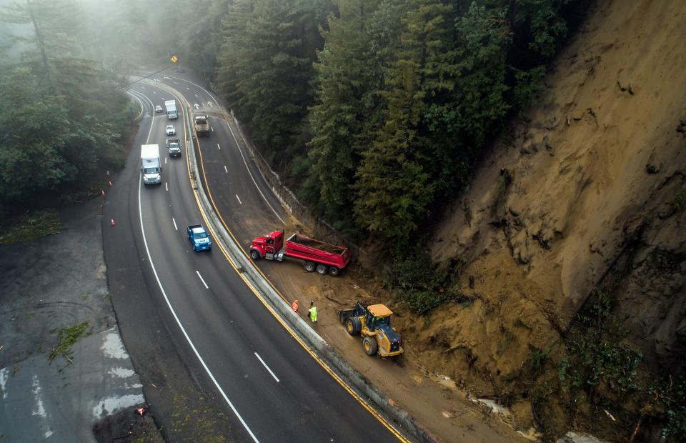 Caltrans crews work to clear a mudslide on Highway 17 that resulted from heavy rain from an atmospheric river storm in the Santa Cruz Mountains, south of Glenwood Drive in Scott's Valley, Calif., on Monday, Jan. 9, 2023.