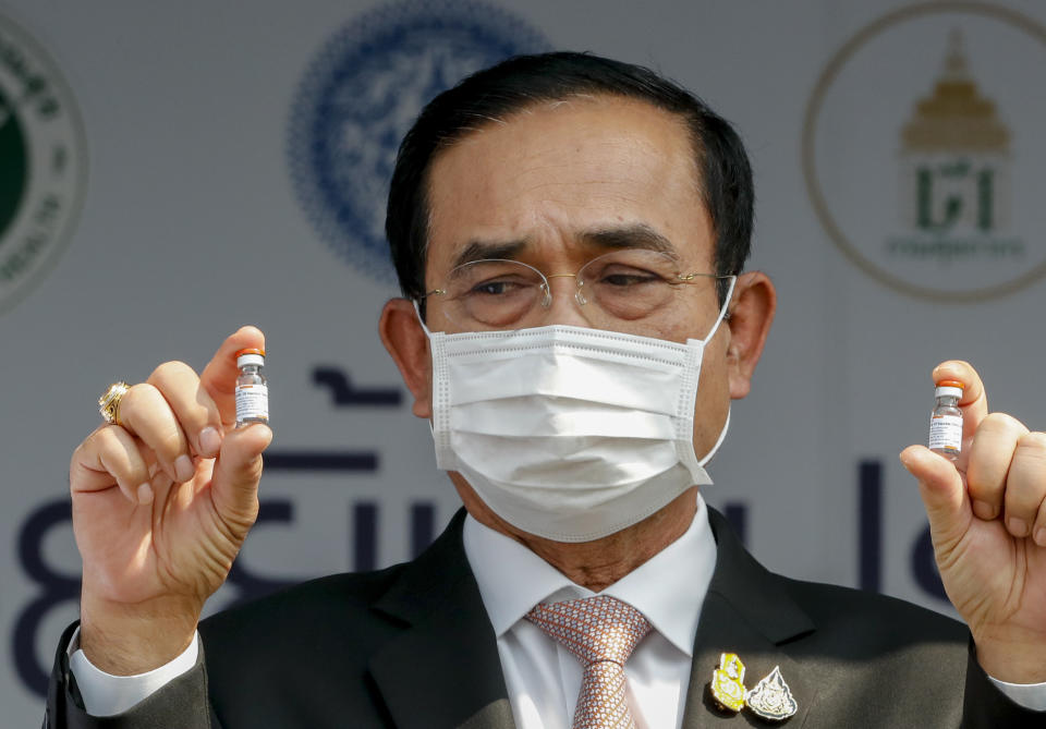 Prime Minister Prayuth Chan-ocha holds samples of Sinovac vaccine during a ceremony to mark the arrival of 200,000 doses of the Sinovac vaccine shipment at Suvarnabhumi airport in Bangkok, Thailand, Wednesday, Feb. 24, 2021. Thailand is schedule to receive first shipments of 200,000 doses of the Sinovac vaccine and 117,000 doses of the AstraZeneca vaccine on Feb. 24. (AP Photo/Sakchai Lalit)