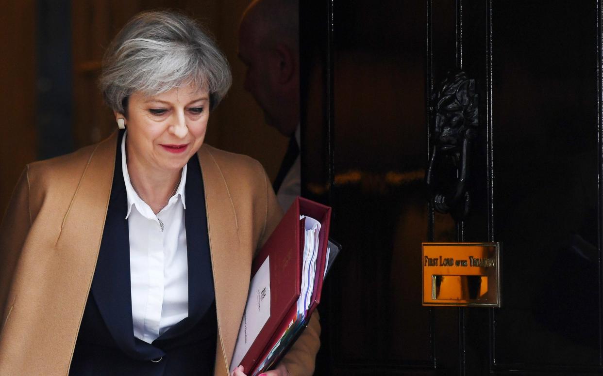 Theresa May leaves Downing Street to deliver her Article 50 statement to Parliament - EPA