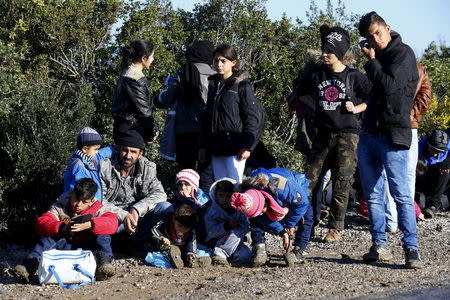 Syrian refugees wait on a roadside near a beach in the western Turkish coastal town of Dikili, Turkey, after Turkish Gendarmes prevented them from sailing off for the Greek island of Lesbos by dinghies, March 5, 2016. REUTERS/Umit Bektas