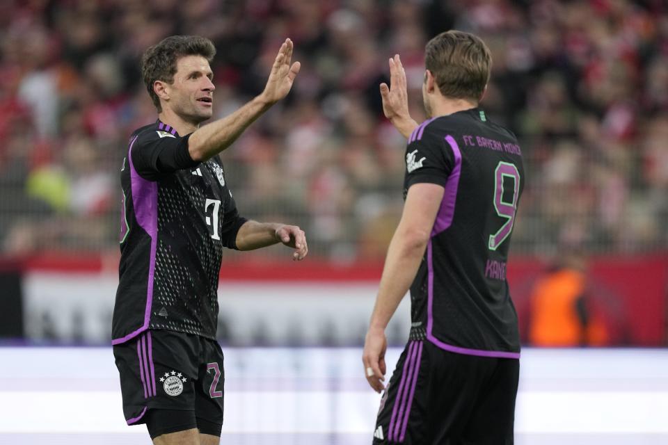 Bayern's Thomas Mueller celebrates with his teammate Harry Kane after scoring his side's fifth goal during the German Bundesliga soccer match between FC Union Berlin and Bayern Munich at the An der Alten Forsterei stadium in Berlin, Germany, Saturday, April 20, 2024. (AP Photo/Ebrahim Noroozi)