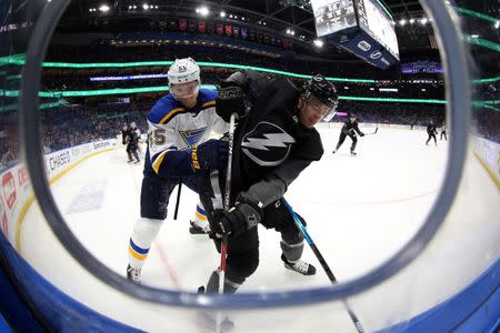 Feb 7, 2019; Tampa, FL, USA; St. Louis Blues defenseman Colton Parayko (55) defends Tampa Bay Lightning right wing Mathieu Joseph (7) on the boards during the third period at Amalie Arena. Mandatory Credit: Kim Klement-USA TODAY Sports