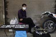 A street vendor wears a protective face mask to help prevent the spread of the coronavirus at the old grand bazaar in the city of Zanjan, some 330 kilometers (205 miles) west of the capital Tehran, Iran, Sunday, July 5, 2020. Iran on Sunday instituted mandatory mask-wearing as fears mount over newly spiking reported deaths from the coronavirus, even as its public increasingly shrugs off the danger of the COVID-19 illness it causes. (AP Photo Vahid Salemi)